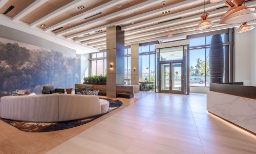 lobby area with seating and large walk in door 