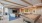 a room with large seating area and a pool table