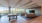 a room with large seating area and a pool table