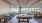 a room with large seating area and a pool table