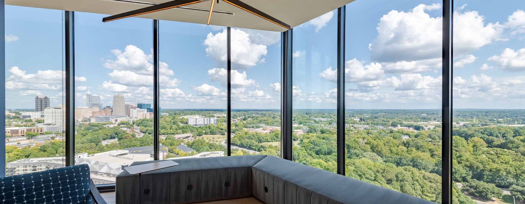 corner office with large windows and bench seating