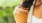 a person holding an ice cream cone