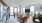 living room with wrap-around windows, a couch and chairs
