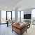 living room with wrap-around windows, a couch and chairs